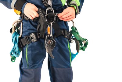 Close up equipment industrial mountaineering worker in uniform on white empty isolated background. Rope access laborer posing in studio. Concept of industry urban works. Copy text space advertising