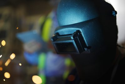 Welders welding steel working in industrial factory, Welders with protective mask